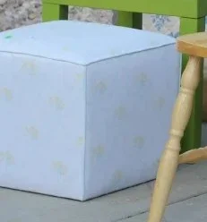 White upholstered cube ottoman